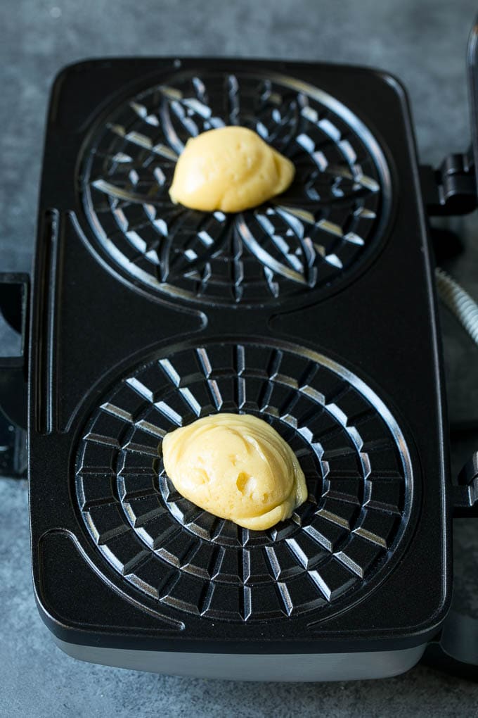 Dollops of dough in a cookie iron.