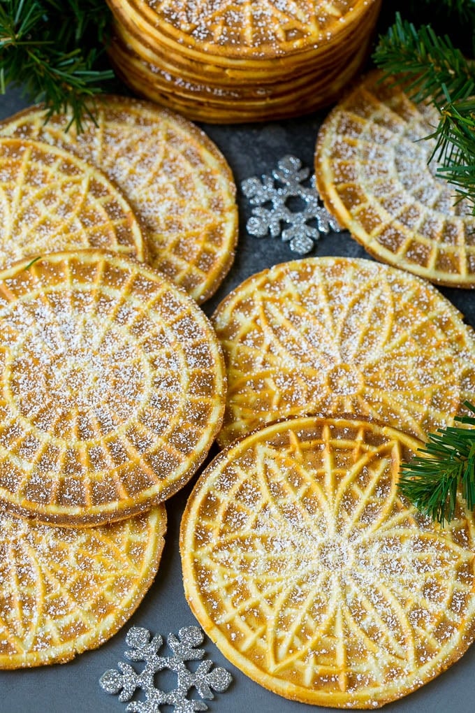 Pizzelle cookies cooked to golden brown and coated in powdered sugar.