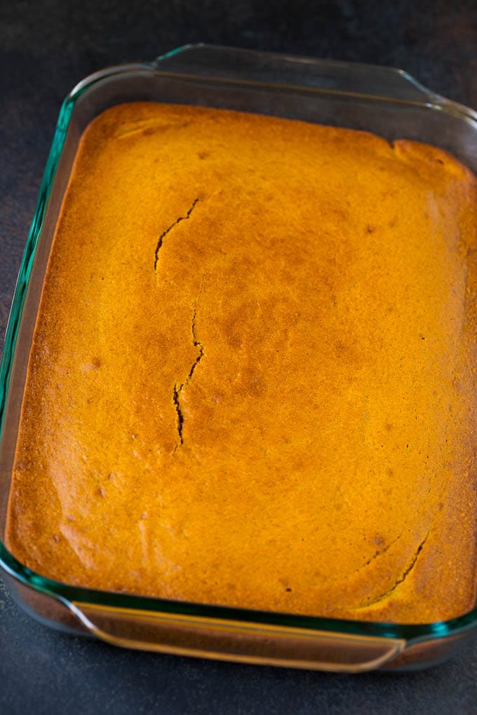 A baked pumpkin spice cake in a glass dish.