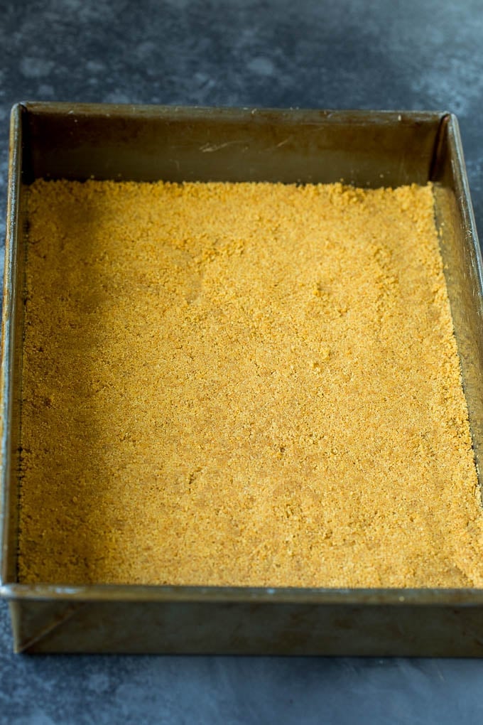 Graham cracker crust in a baking dish.