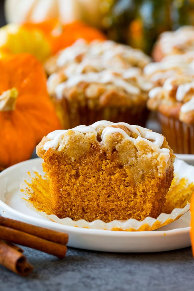 Pumpkin muffins topped with brown sugar streusel and vanilla glaze.