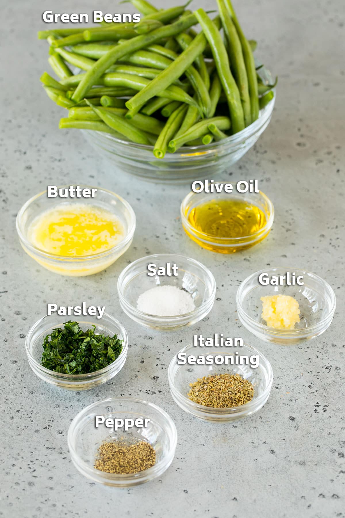 Bowls of ingredients including green beans, olive oil, butter and seasonings.