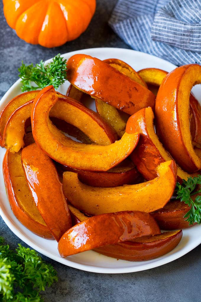 A plate of roasted pumpkin garnished with parsley.