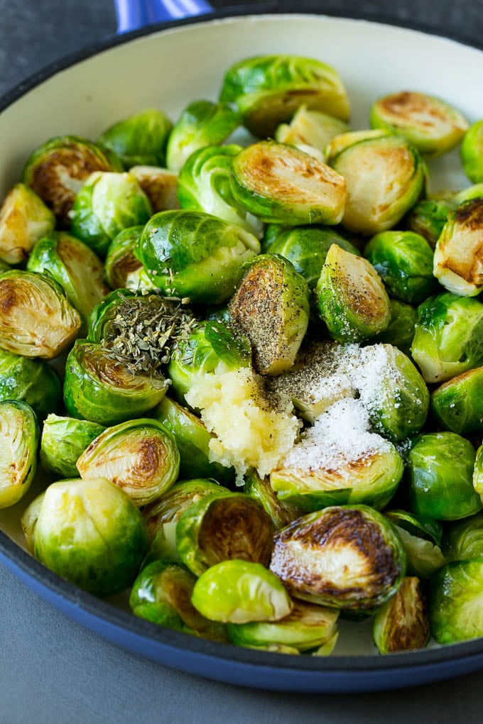 Sprouts in a pan seasoned with salt, pepper, garlic and dried herbs.