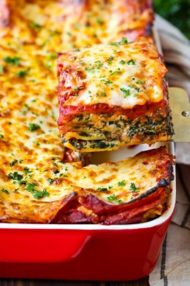 A spatula serving up a slice of spinach lasagna.