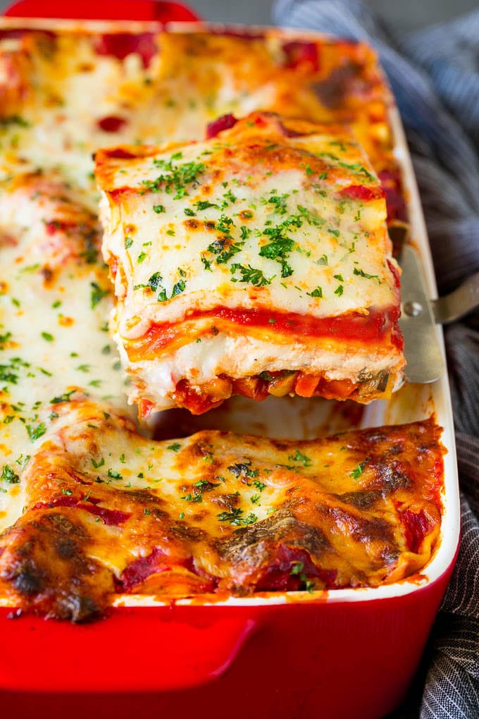 A spatula serving up a portion of vegetable lasagna.