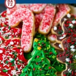 These Christmas sugar cookies are roll out cookies that are frosted with an easy vanilla buttercream and decorated with sprinkles.