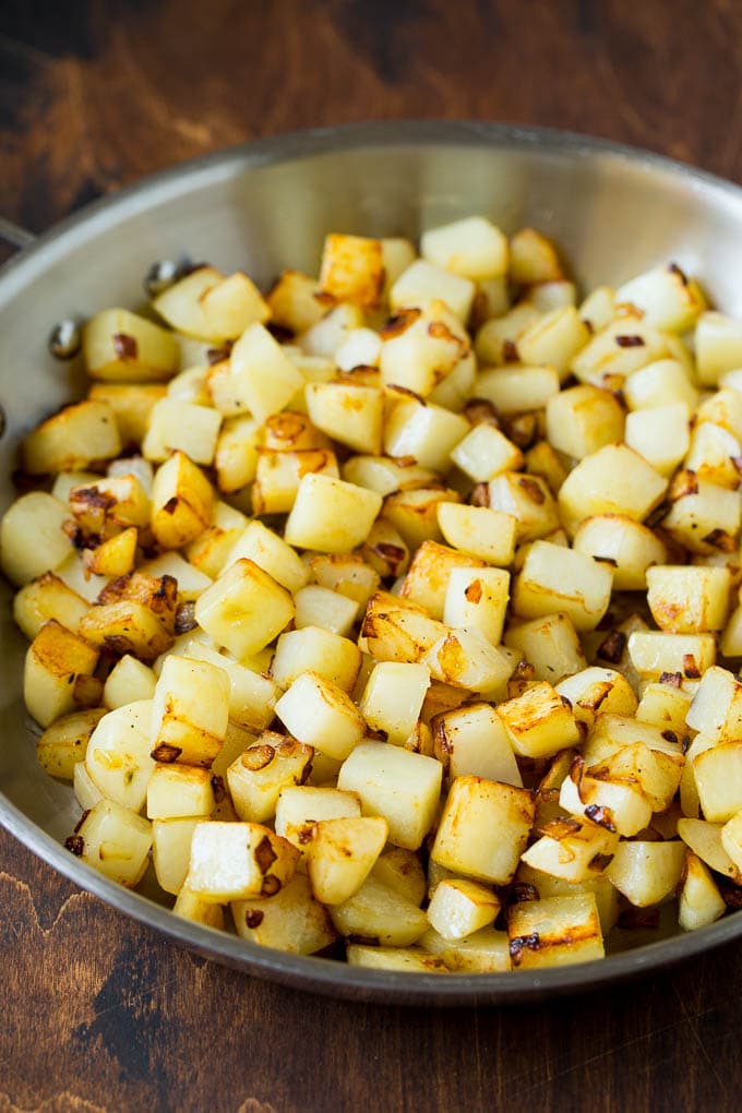 Sauteed potatoes in a skillet.