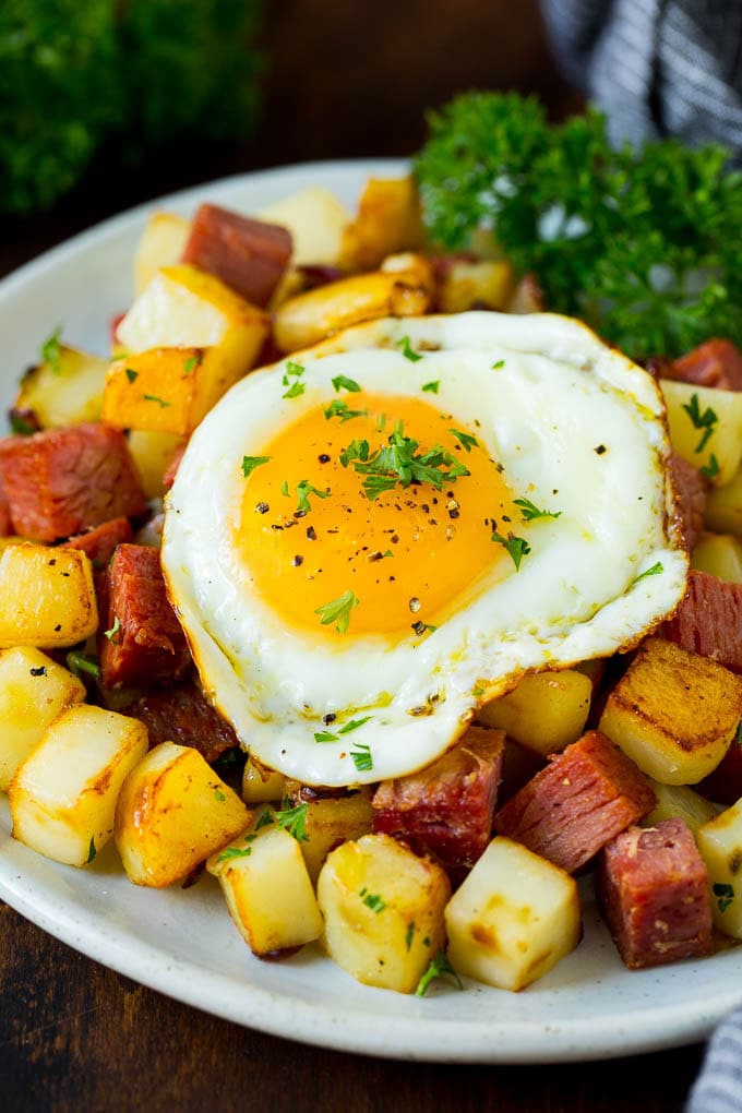 A plate of corned beef hash topped with a fried egg.