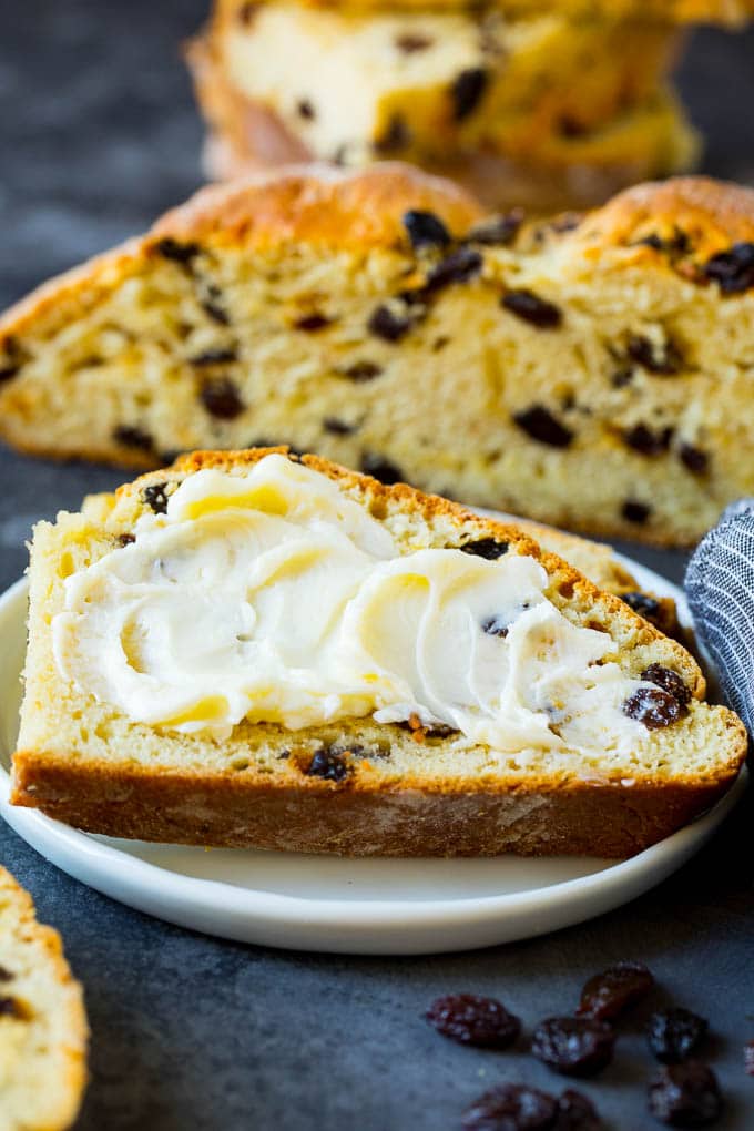 A slice of Irish soda bread with butter spread on it.