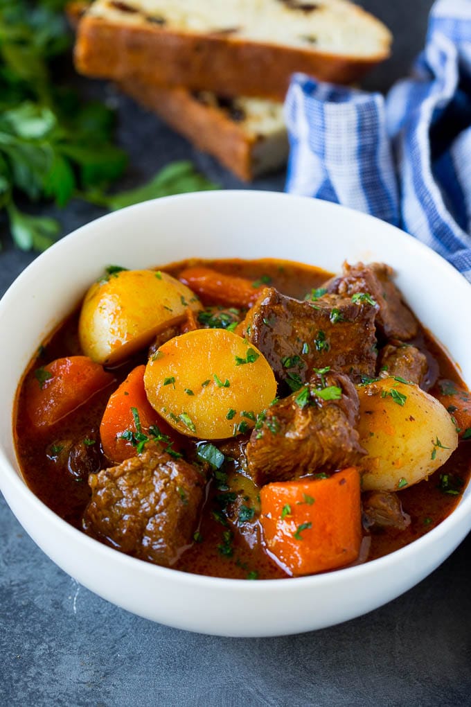 A bowl of Irish stew garnished with parsley.