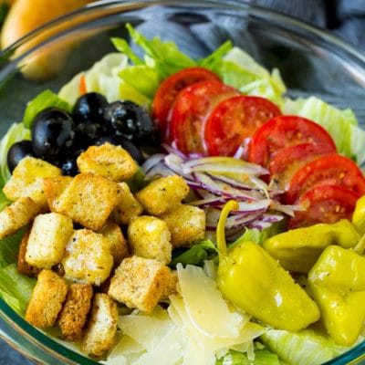 Olive Garden salad with tomatoes, croutons, cheese and olives.