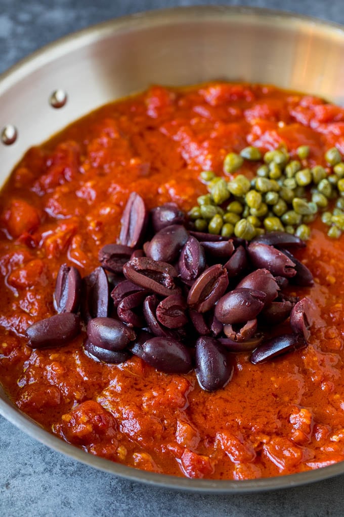 Tomato sauce with olives and capers on top.