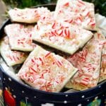 Pieces of peppermint bark in a holiday tin.