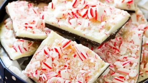 Pieces of peppermint bark in a holiday tin.