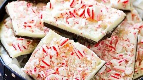 Pieces of peppermint bark in a holiday tin.