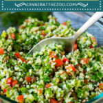 An image of tabbouleh salad in bowl which is a bulgur wheat salad made with fresh herbs, tomatoes and cucumber, all tossed together in a simple lemon dressing.