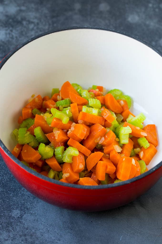 Carrots, onions and celery in a soup pot.