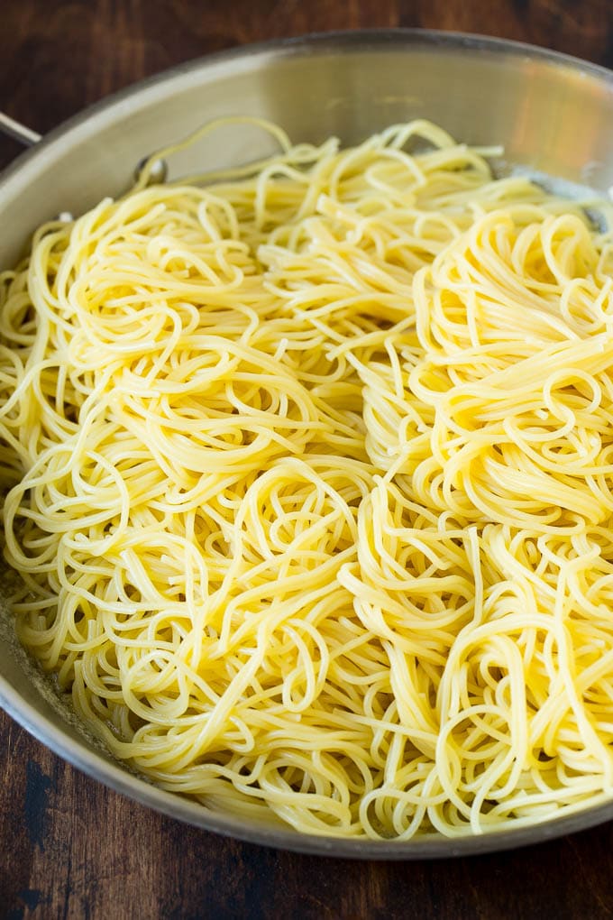 Pasta in a pan with garlic and butter.
