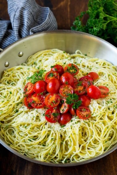 Garlic and herb angel hair pasta topped with fresh tomatoes.