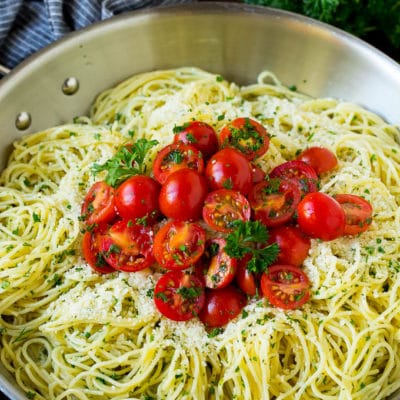 Garlic and herb angel hair pasta topped with fresh tomatoes.