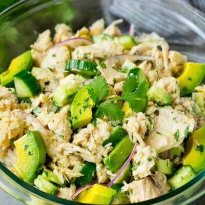 A serving bowl of avocado tuna salad topped with cilantro.
