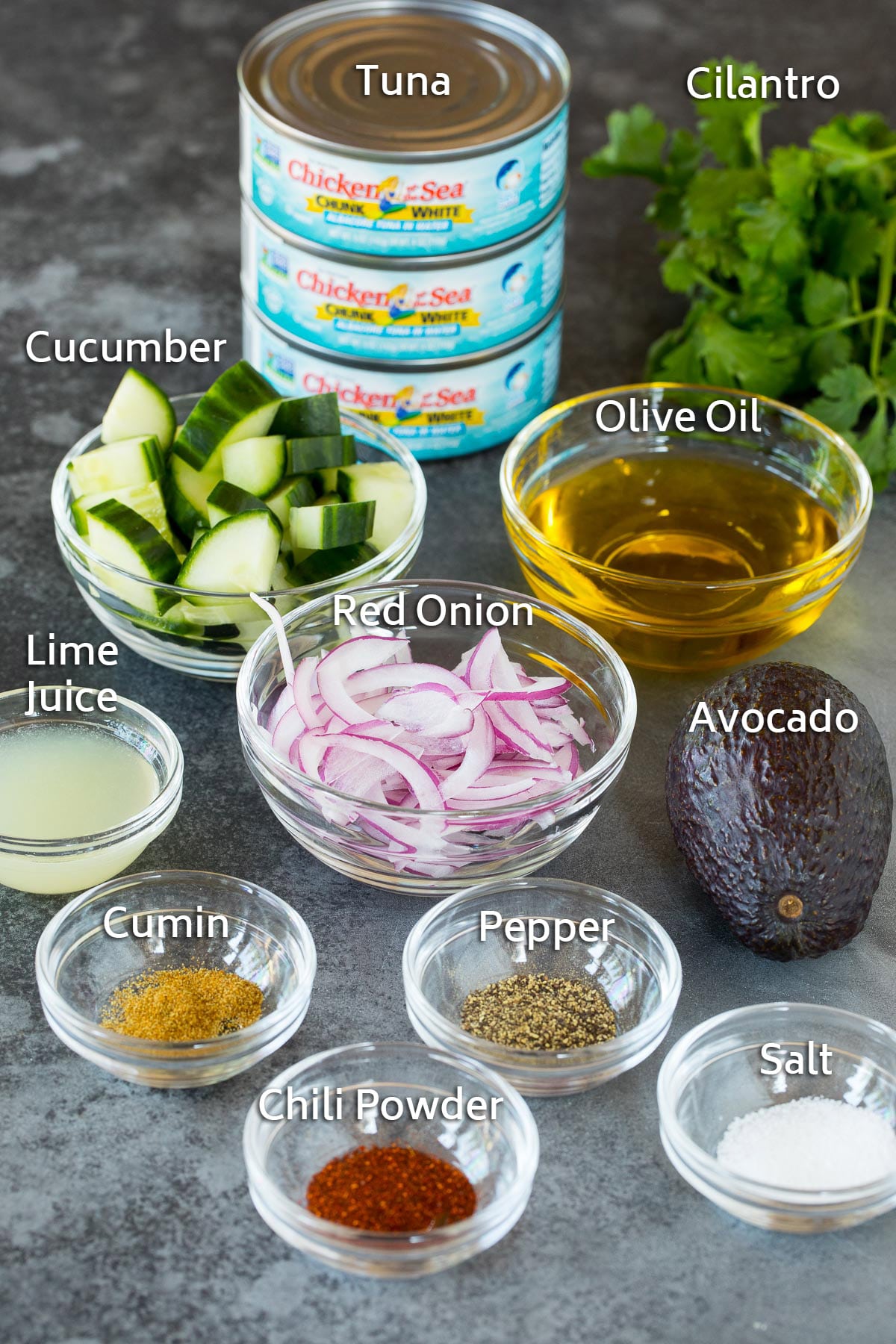 Bowls of ingredients including lime juice, vegetables and seasonings, and cans of tuna.