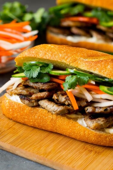 A bahn mi sandwich layered with pork, pickled vegetables and herbs.