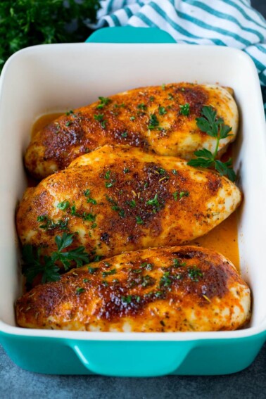 Baked chicken breast topped with fresh chopped parsley.
