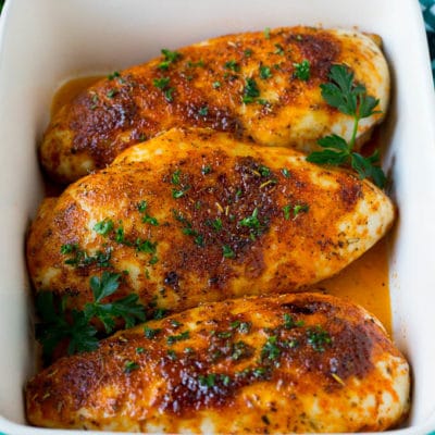 Baked chicken breast topped with fresh chopped parsley.