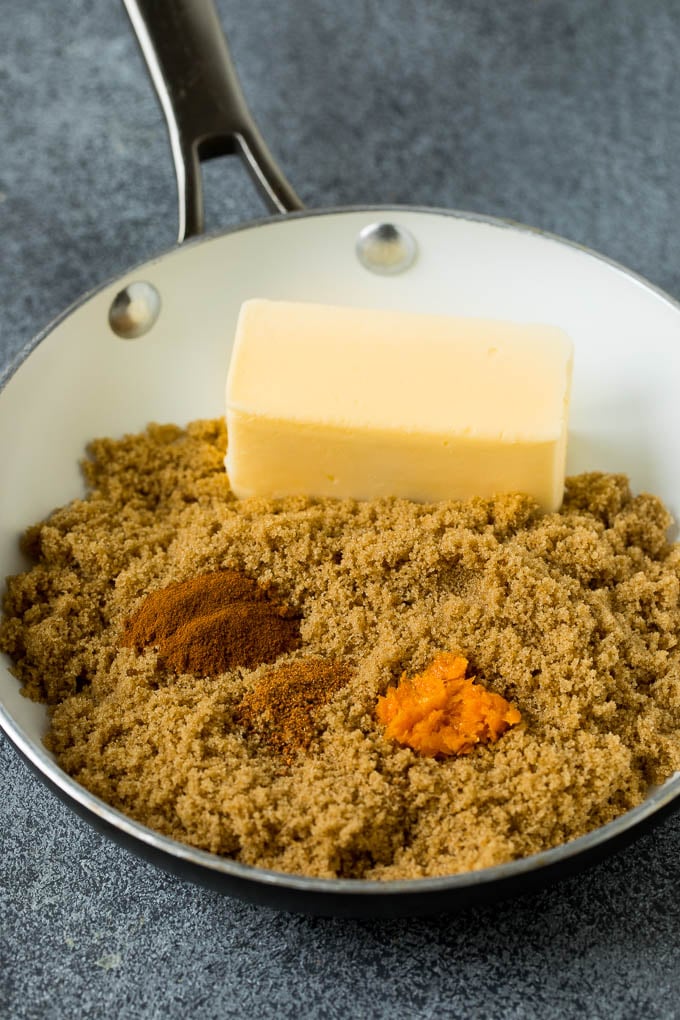 Brown sugar, butter, orange zest and spices in a pan.