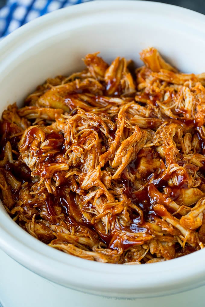 Shredded crockpot BBQ chicken in a slow cooker.