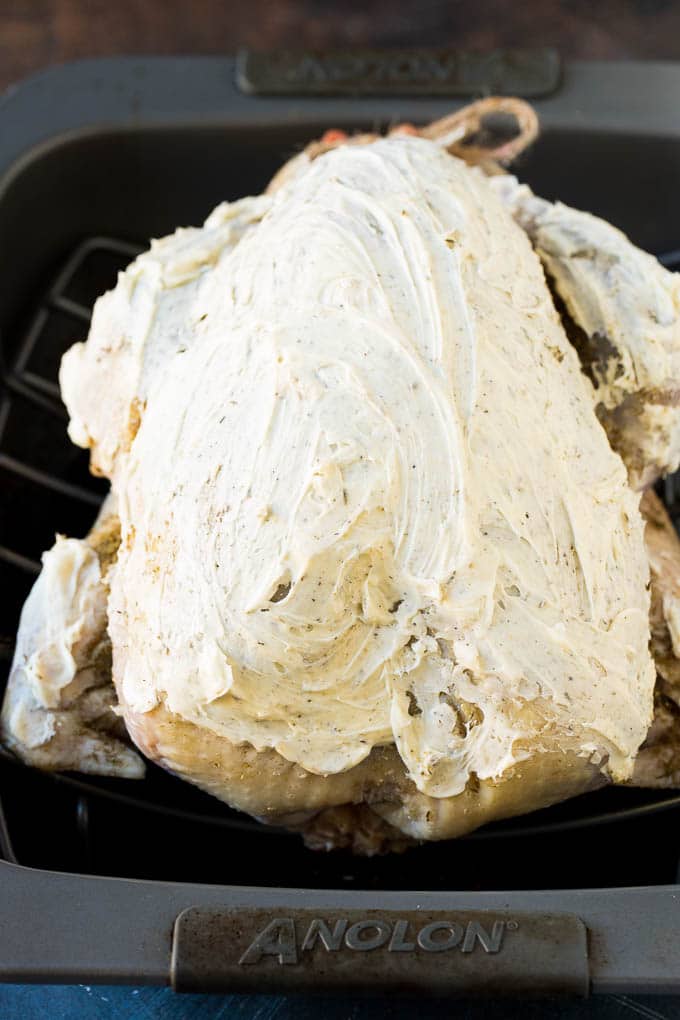 This dry brined turkey is coated in a blend of salt, herbs and spices, then roasted to golden brown perfection. A turkey with seasoned butter all over it.