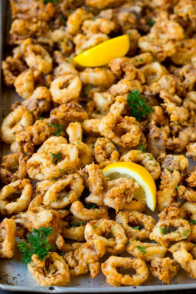 Fried calamari garnished with lemon and parsley.