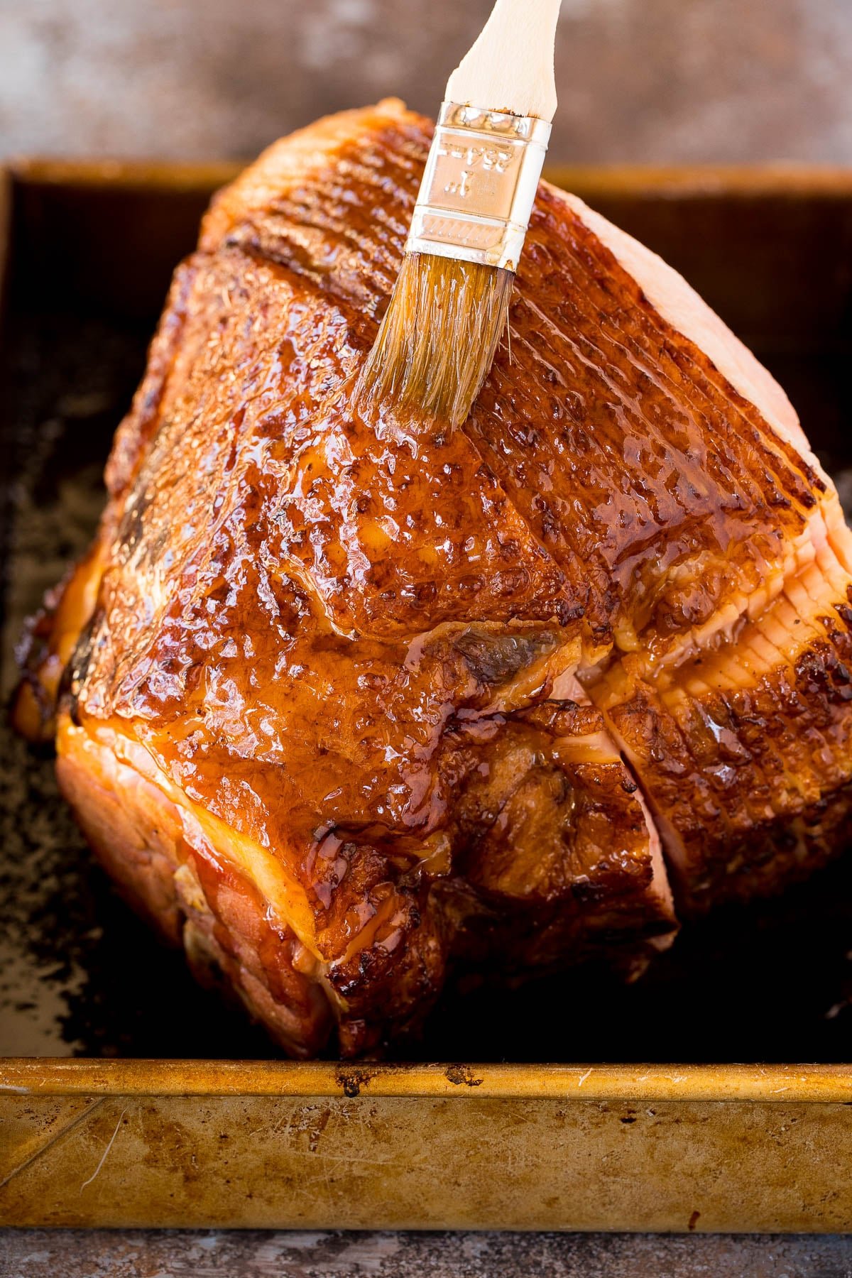 A brush adding sauce to the baked pork.