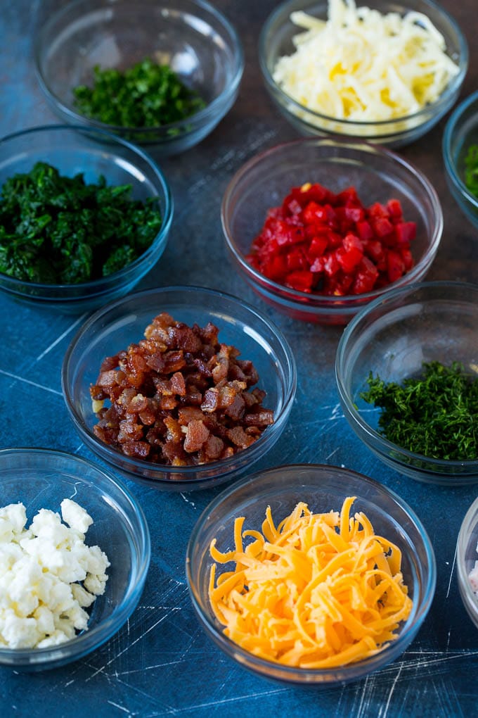 Bowls of assorted flavorings for quiche.