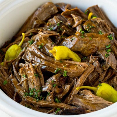 A slow cooker filled with shredded Mississippi pot roast.