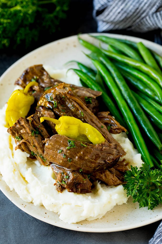 MIssissippi pot roast served over mashed potatoes with green beans.