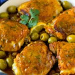 Moroccan chicken with olives and raisins in a skillet.