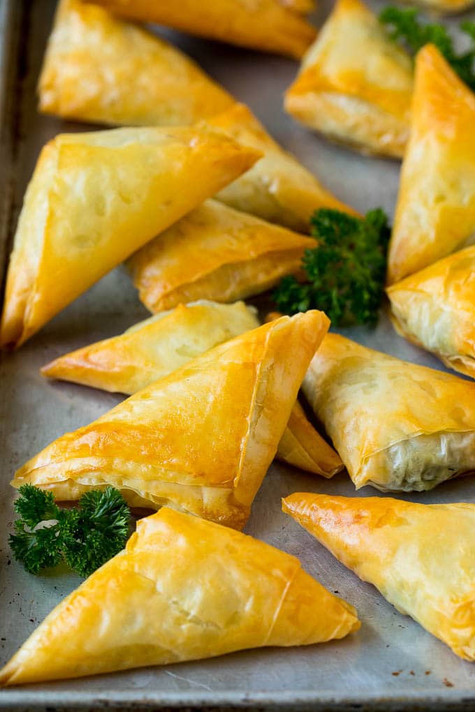 Baked spanakopita filled with spinach and cheese.