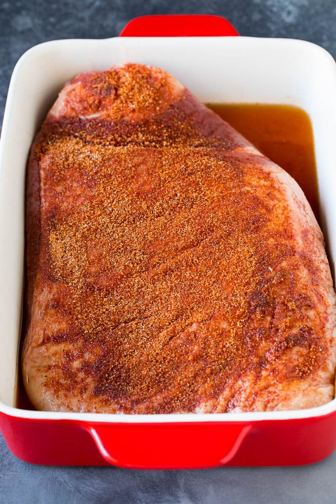 A brisket coated in homemade spice rub.