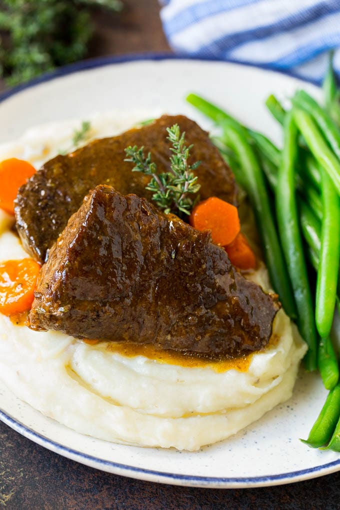 Braised short ribs served over mashed potatoes with green beans.