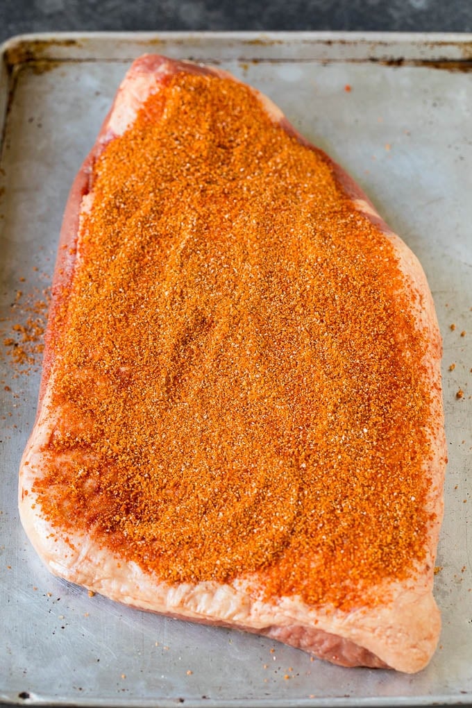 Brisket rub spread over a beef brisket.