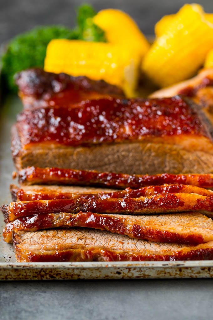 Sliced beef brisket on a sheet pan.