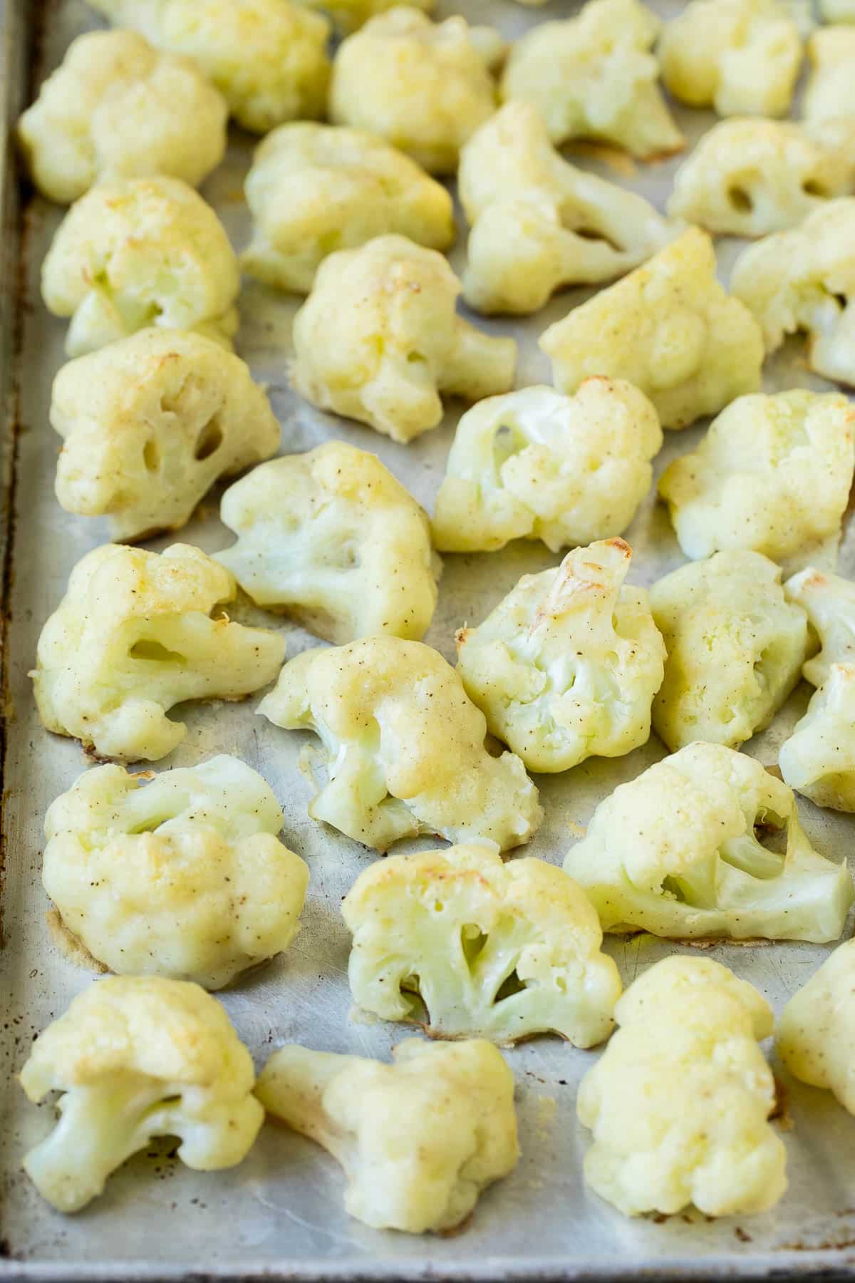 Battered and cooked cauliflower on a pan.