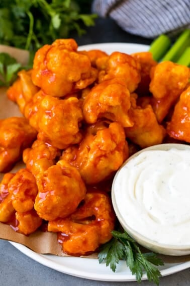 Buffalo cauliflower bites served with ranch and celery.
