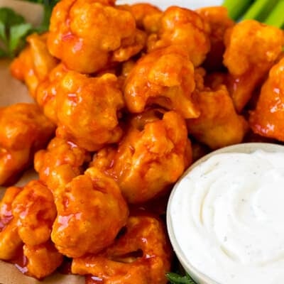 Buffalo cauliflower bites served with ranch and celery.