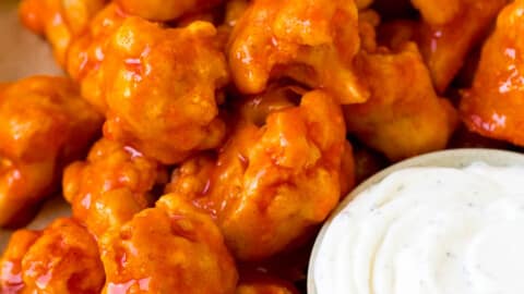 Buffalo cauliflower bites served with ranch and celery.