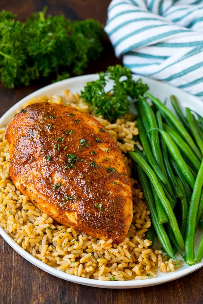 Cajun chicken served over rice with a side of green beans.