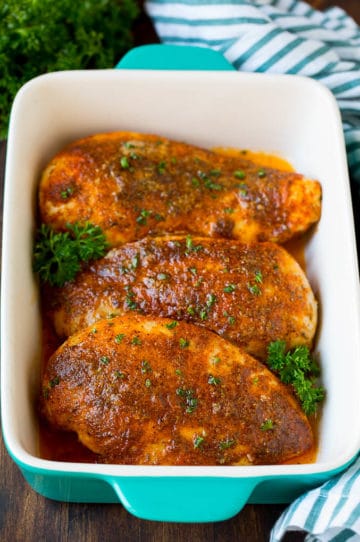 Baked Cajun chicken garnished with fresh parsley.